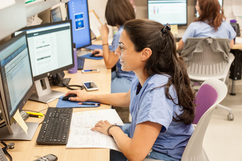 A medical student fills out an application on a computer