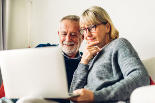 Man and woman looking at a computer