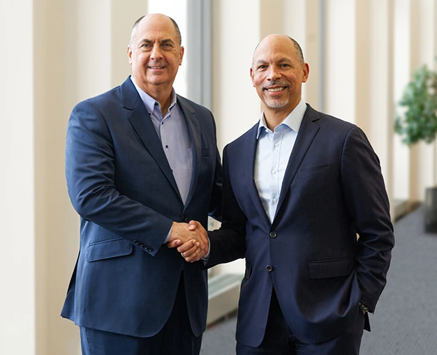 Jim Skogsbergh and and Eugene A. Woods shaking hands