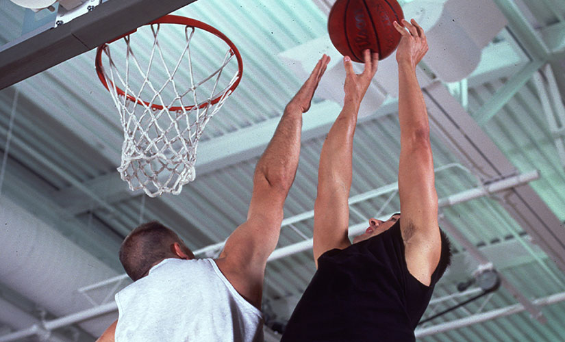 Two men playing basketball